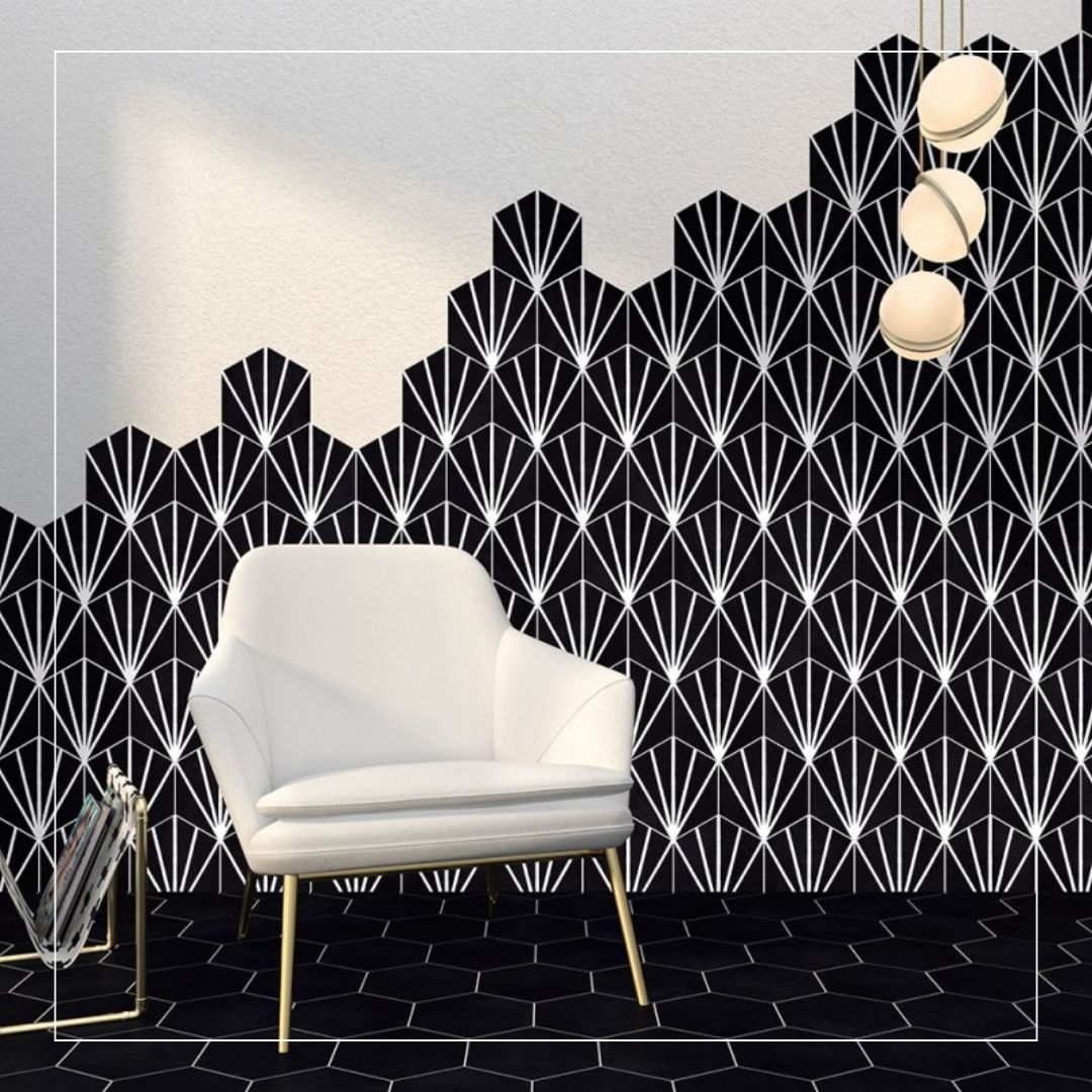 bold black tiles with a white geometric fan pattern on the wall and matching black hexagonal floor tiles
