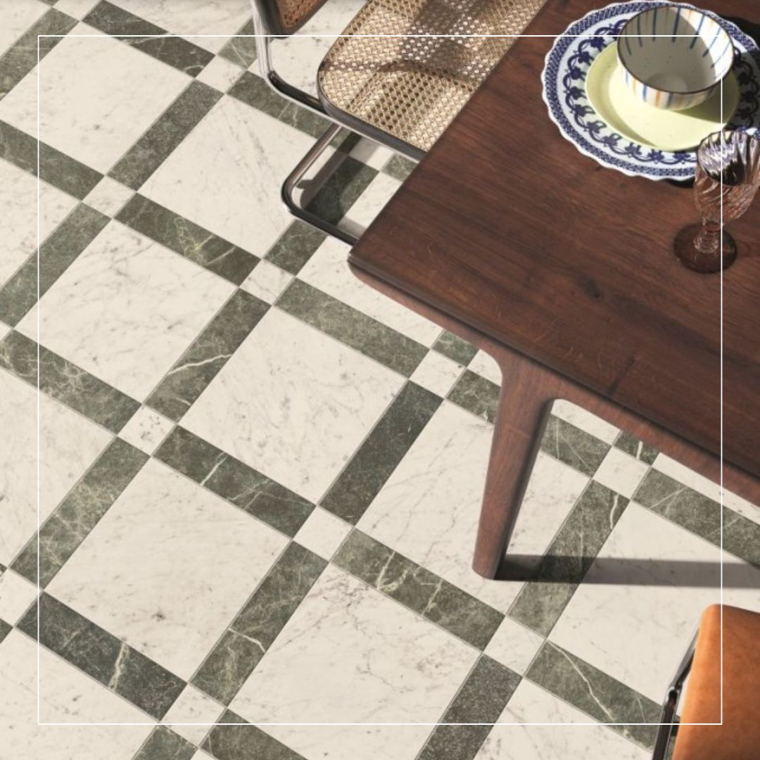 Black and white marble-effect floor tiles arranged in an inset rug layout with contrasting dark borders.