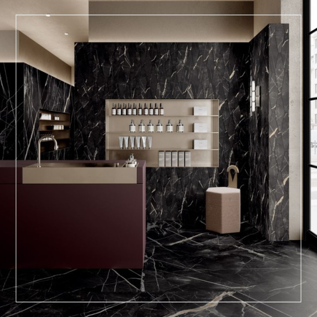 Modern commercial interior featuring luxurious black marble-effect floor and wall tiles with striking white and gold veining