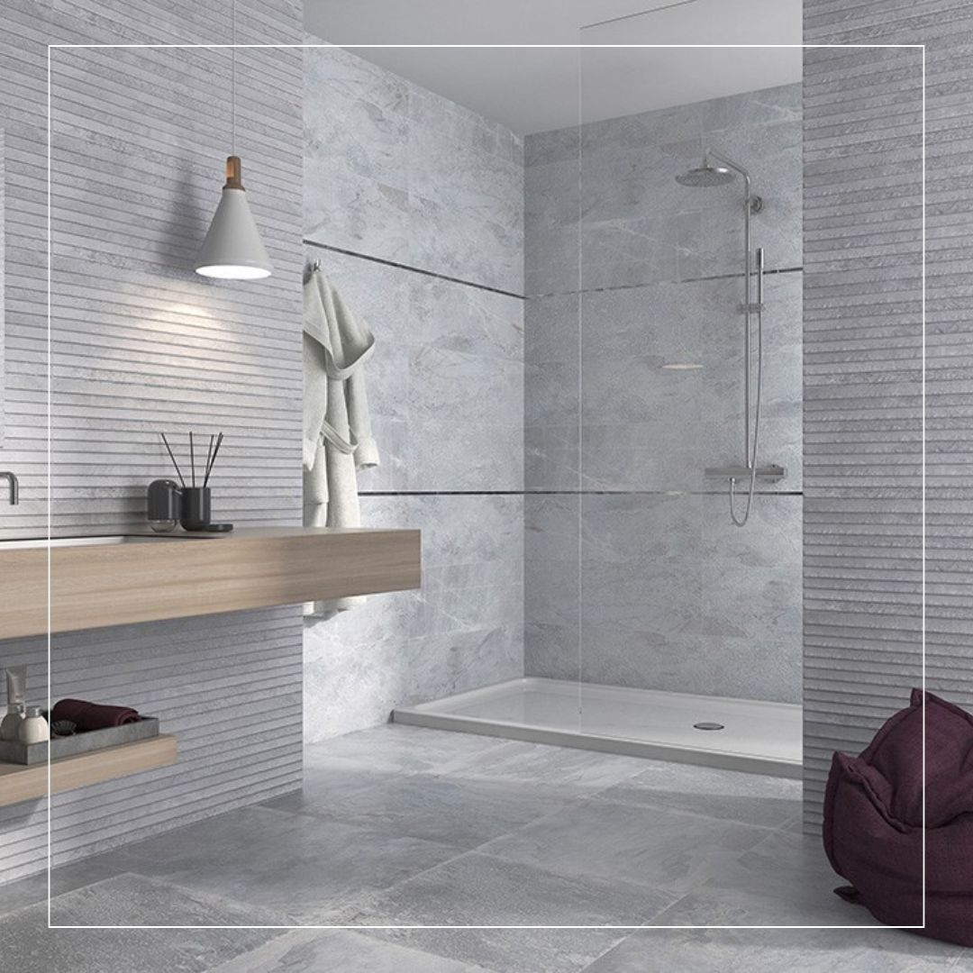 Modern bathroom featuring grey marble-effect porcelain tiles on the floor and shower walls, complemented by textured horizontal wall tiles and a sleek walk-in shower design.