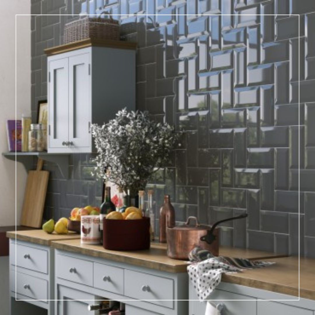 Stylish kitchen featuring glossy grey ceramic tiles used as a textured kitchen splashback, creating a modern geometric design above wooden worktops and shaker cabinets.