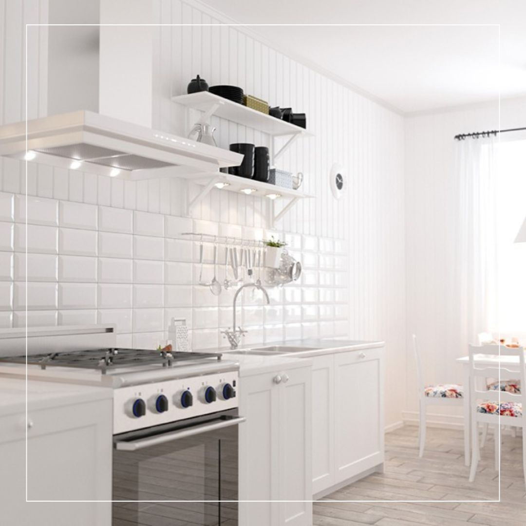 Bright white kitchen featuring glossy ceramic tiles used as a classic kitchen splashback, paired with shaker cabinets and light wood-effect flooring for a clean modern look.