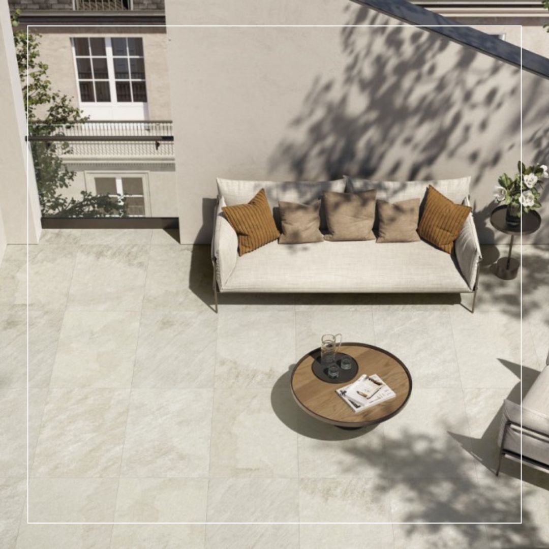 Large format light grey outdoor porcelain tiles installed on a modern terrace seating area.