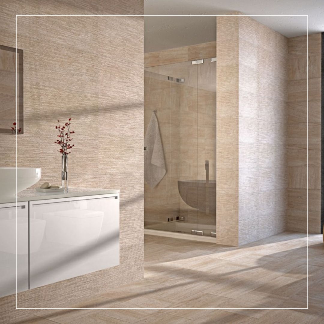 Modern bathroom with beige textured porcelain tiles on walls and floors, featuring a walk-in shower and minimalist vanity for a warm contemporary look