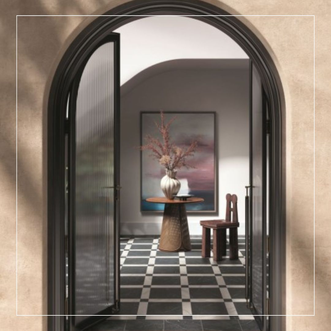 charcoal slate-effect porcelain floor tiles with pale stone borders, laid in a framed grid pattern for a classic hallway style