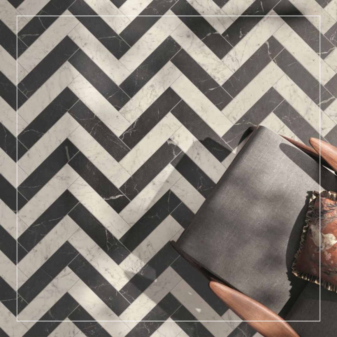 “Chevron-pattern floor tiles in contrasting black and white, marble-look finish