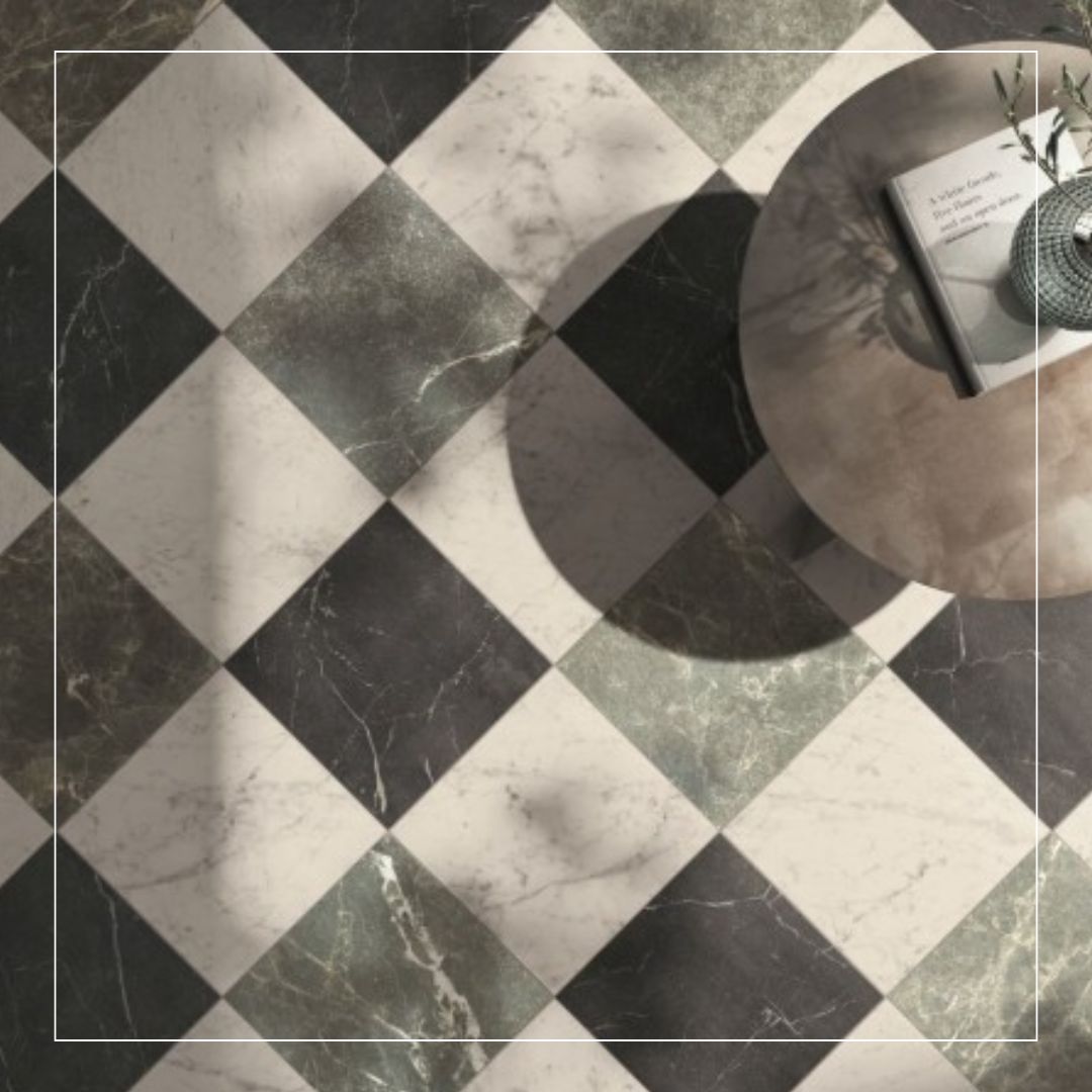 chequerboard marble-effect porcelain floor tiles in black, white and grey, shown on the diagonal beneath a round side table