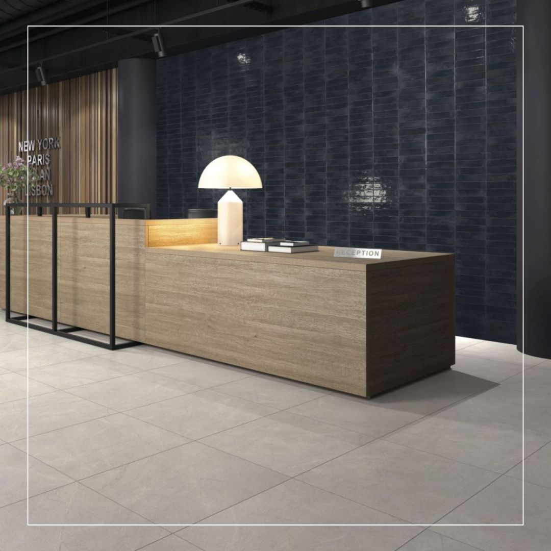 Commercial interior with a feature wall of dark blue glossy tiles laid in a horizontal patter and light grey floor tiles