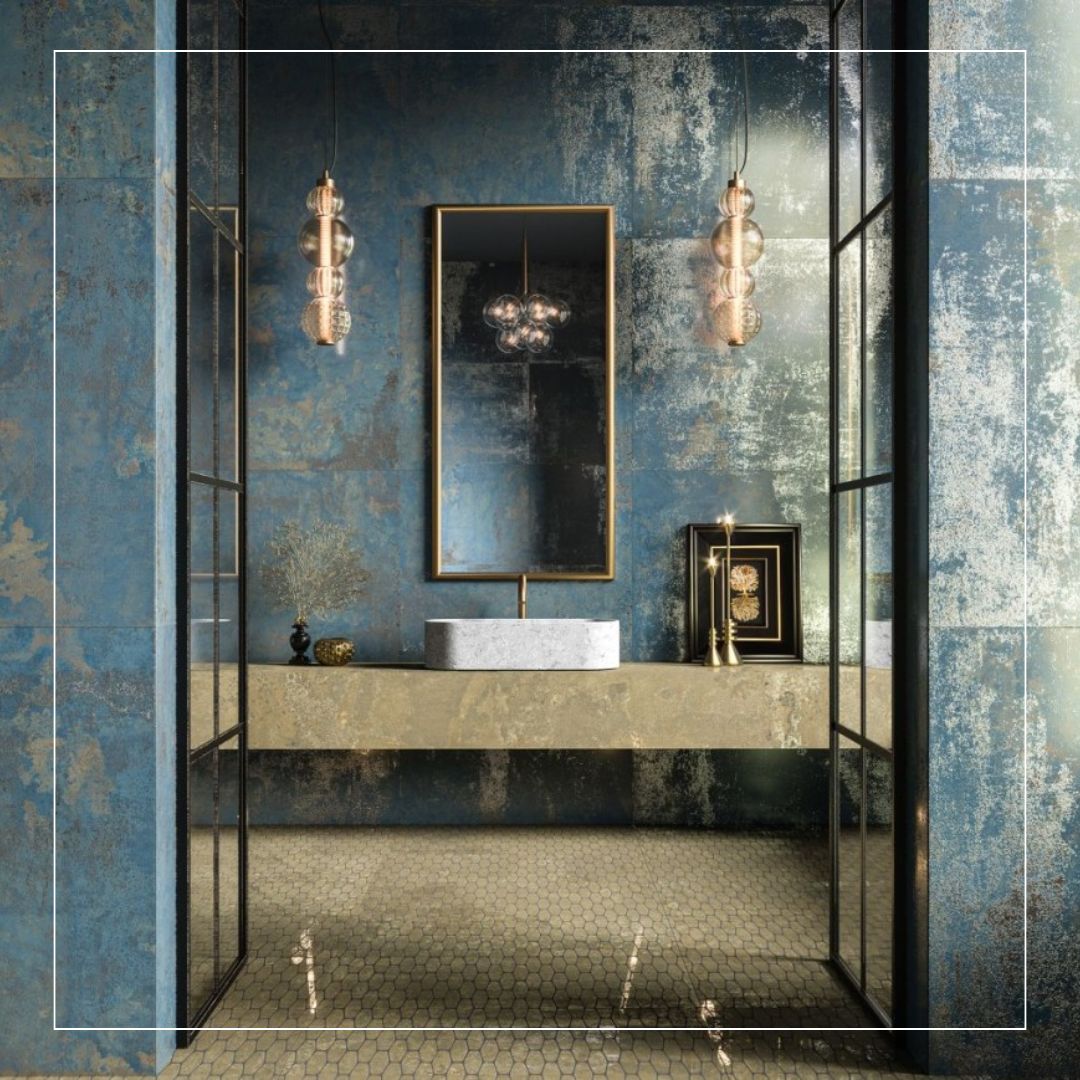 Bathroom interior with textured blue wall tiles featuring metallic gold accents