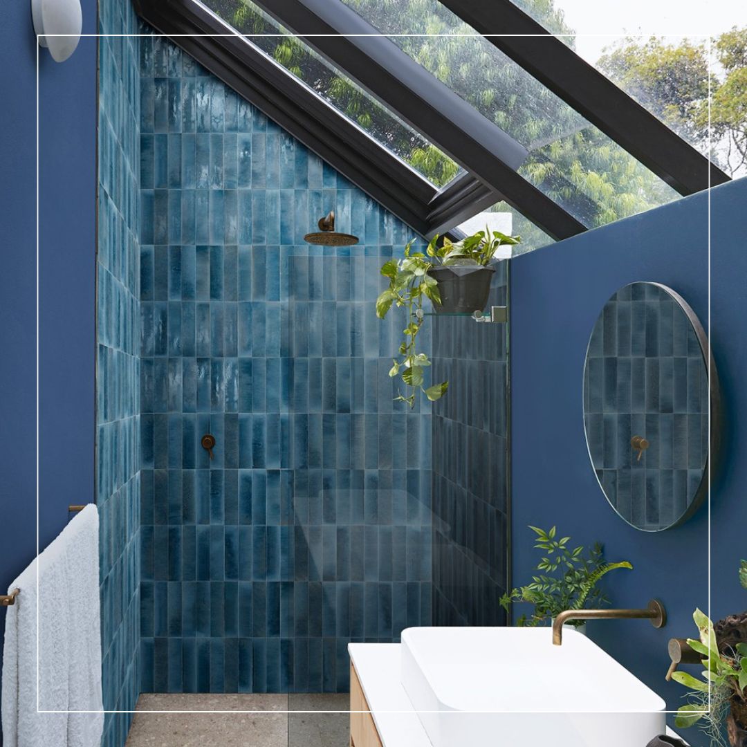 Modern bathroom with deep blue glazed wall tiles in a vertical layout