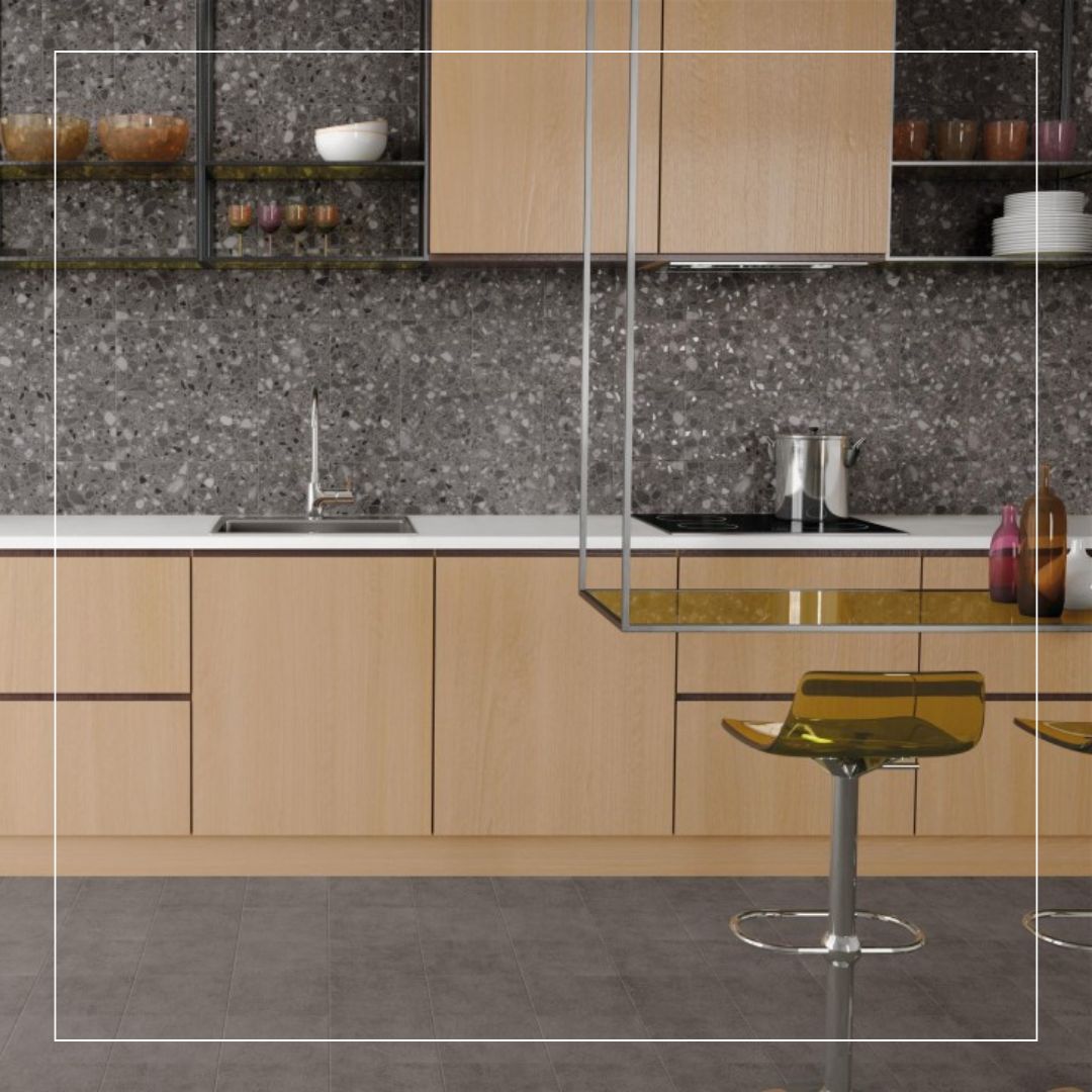 Modern kitchen with wooden cabinets, grey terrazzo effect splashback tiles, and contemporary open shelving