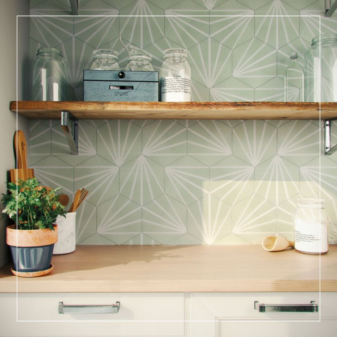 Close-up of modern kitchen with geometric patterned splashback tiles in soft green tones and wooden shelf