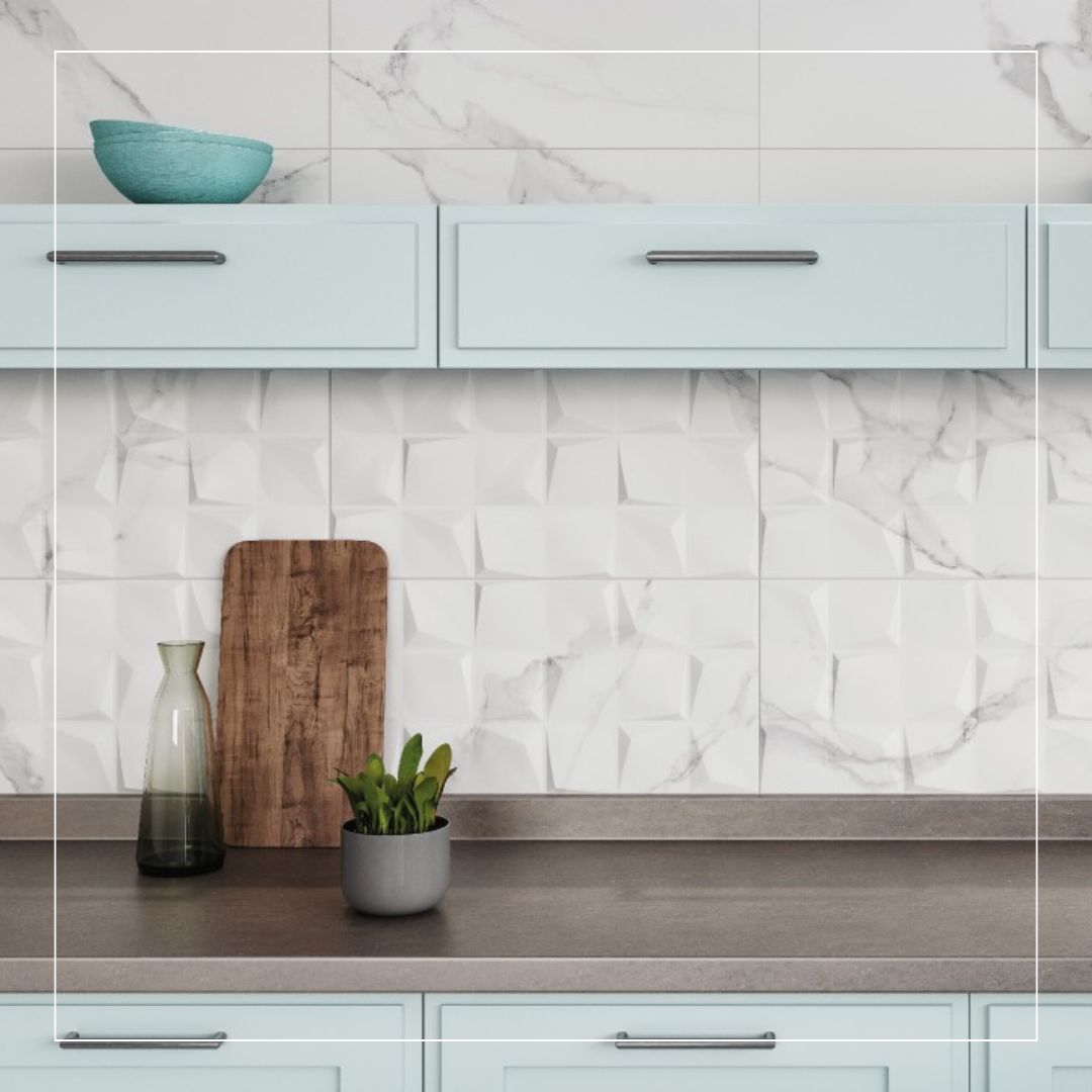 Modern kitchen with light blue cabinets, grey worktop, and white 3D textured splashback tiles with marble effect