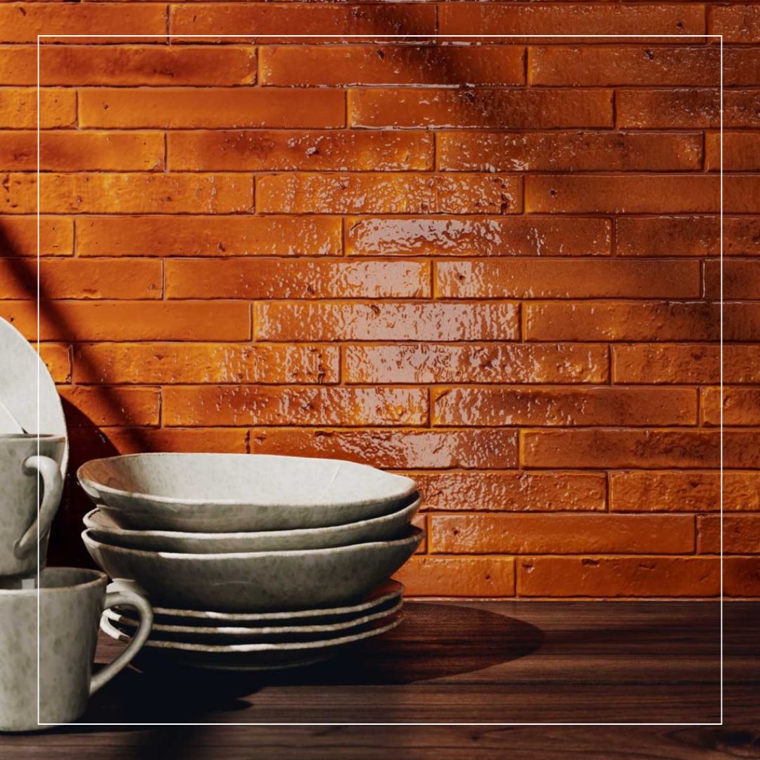 Close-up of rustic kitchen splashback with glossy red brick effect tiles