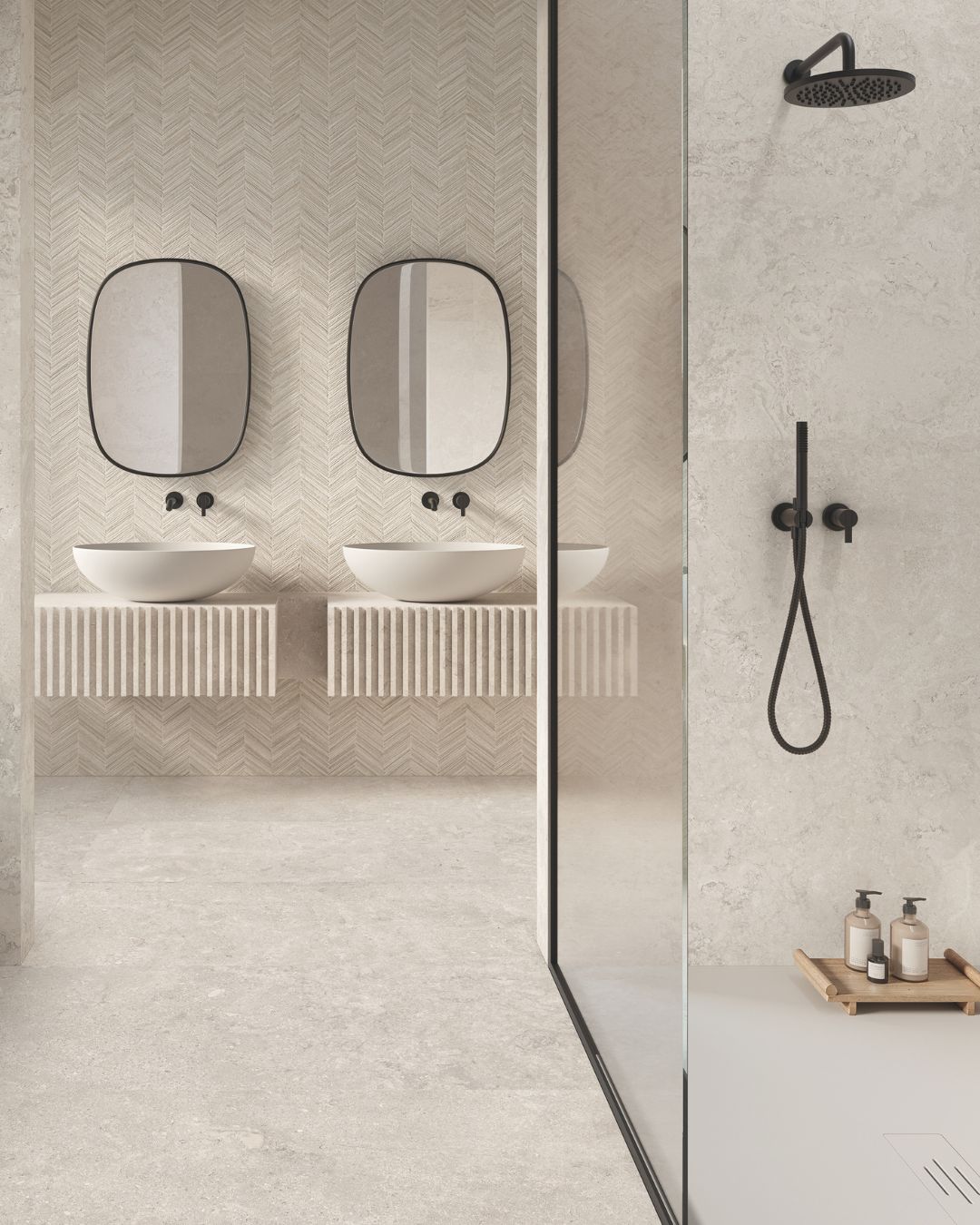 Modern wet room with large grey stone-effect floor tiles, walk-in shower, glass screen, black shower fittings and double washbasins