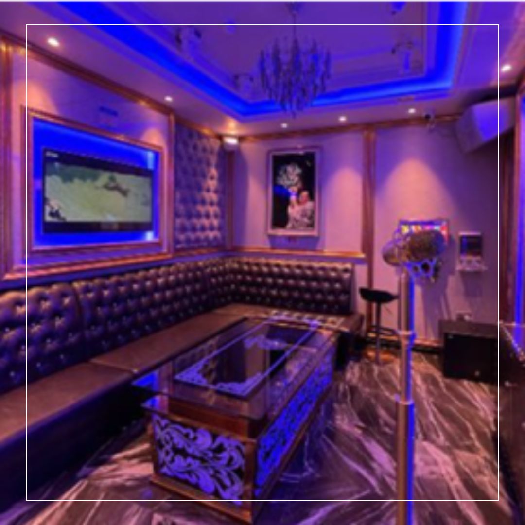 Private karaoke room with Future Stone Grey flooring and luxe seating — hospitality fit-out by a commercial tiling contractor in Southsea, Portsmouth.